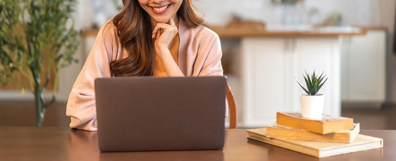 A woman using a laptop at home.
