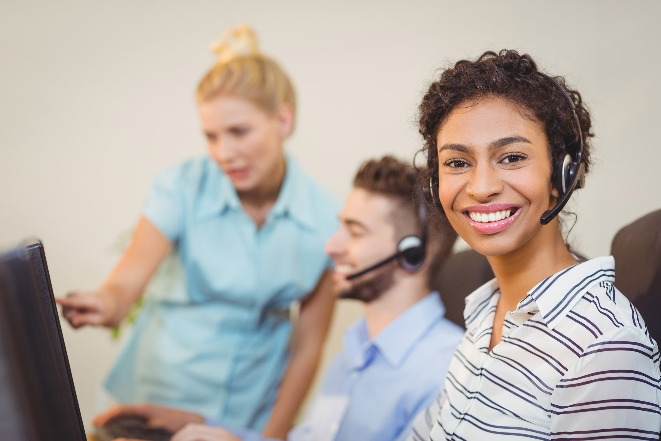 A customer support representative wearing a headset.