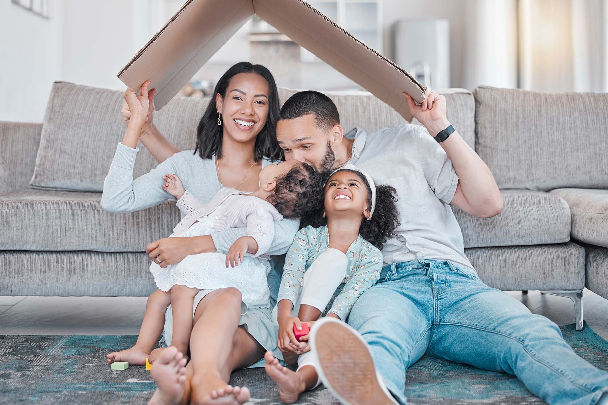 A family sitting together on a sofa.