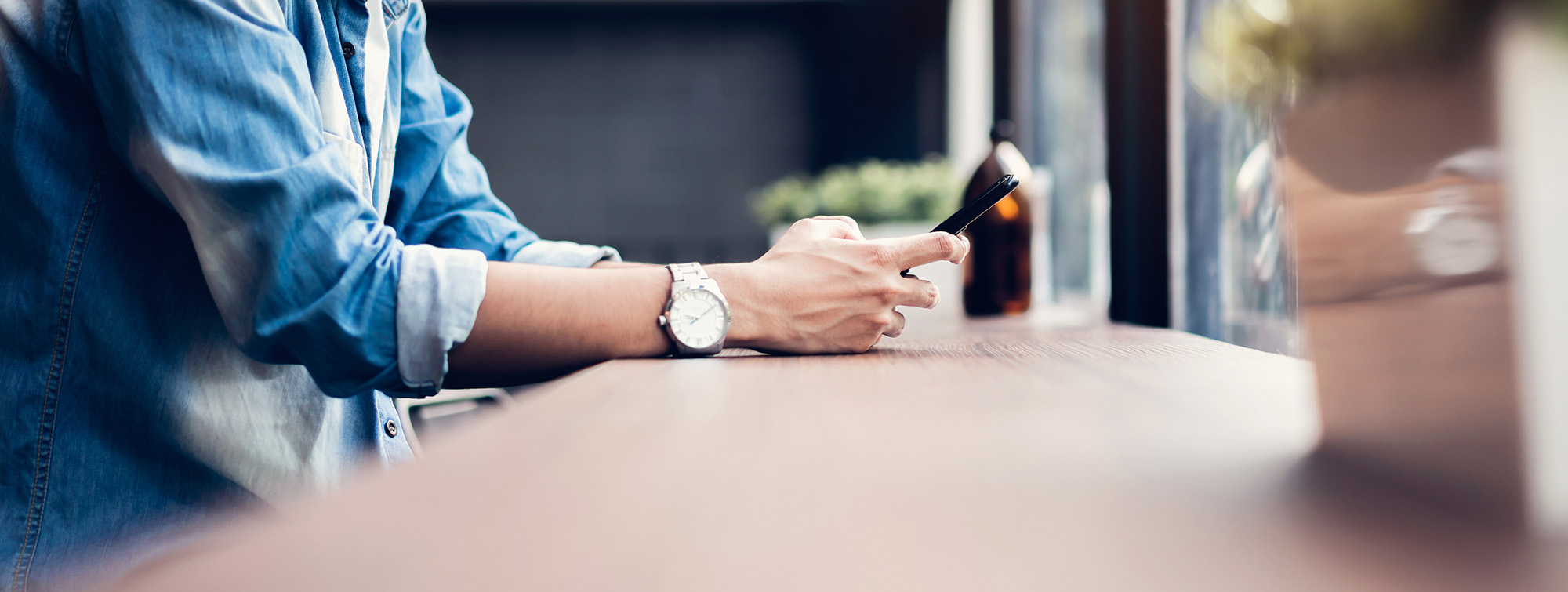 A person using a phone at a desk.