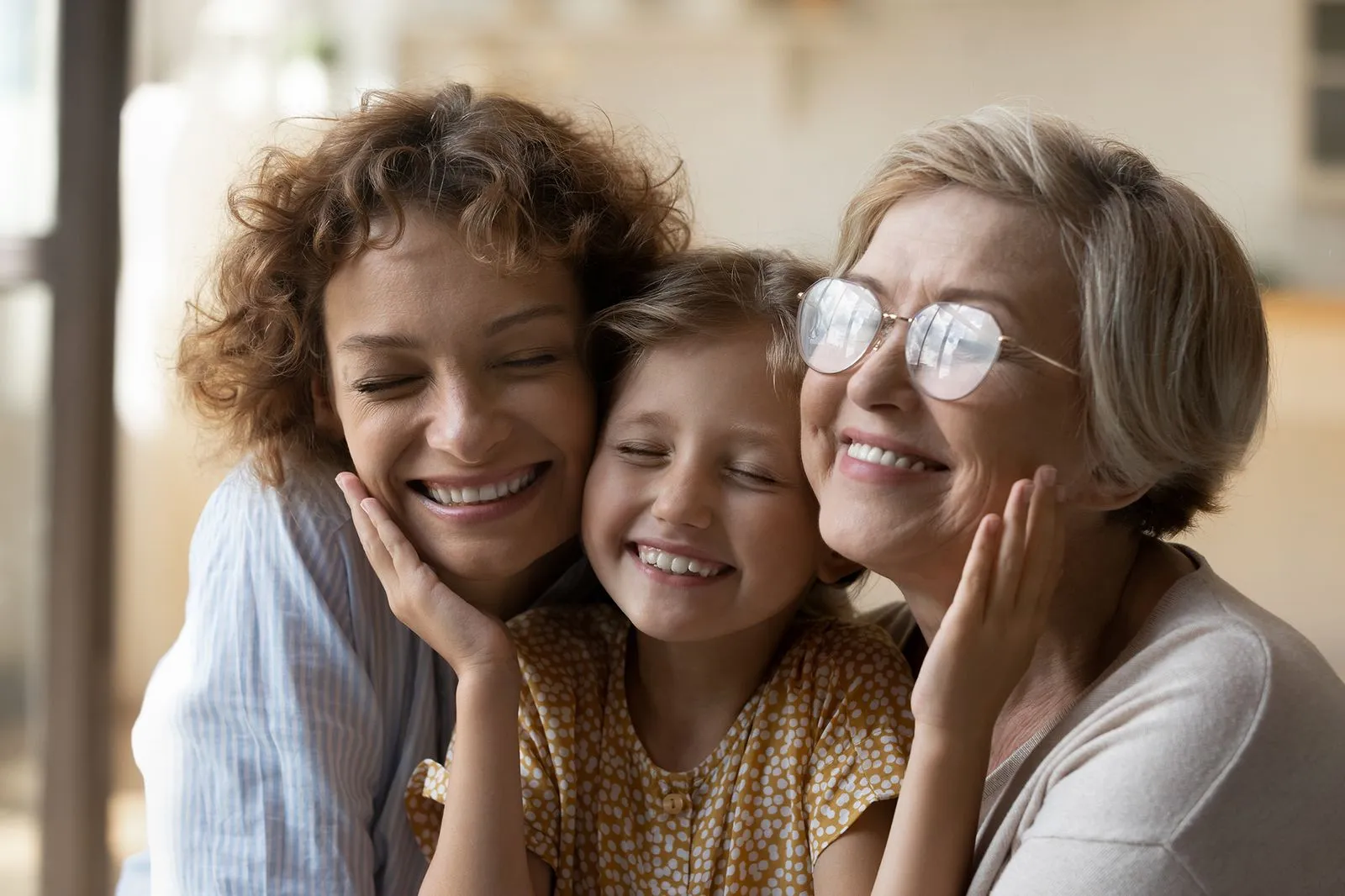 Three generations of a family smiling together.